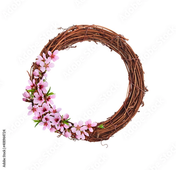 Fototapeta Dry brown rattan wreath with pink spring flowers isolated on white background for Easter