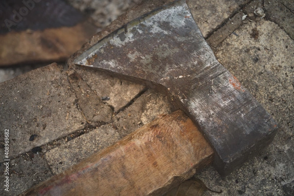 Fototapeta old rusty axe lies on stone tool logger horizontal macro photo