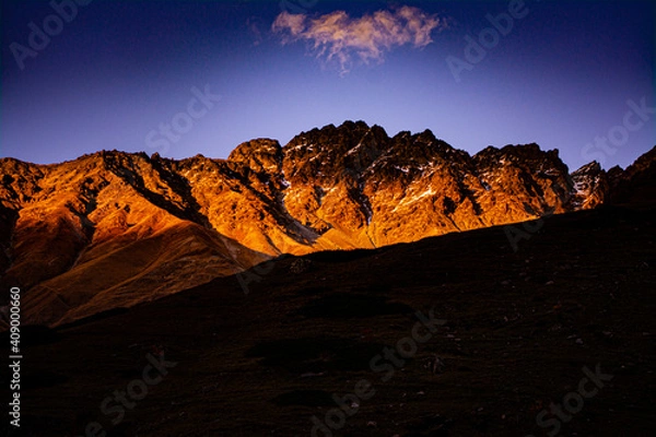 Fototapeta Sunset rays over the mountain