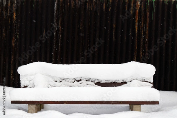 Obraz View on a snow-covered bench