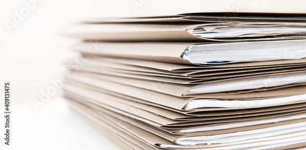 Fototapeta Extremely Close up Stack of Documents Folders on Office Desk Waiting to be Completed