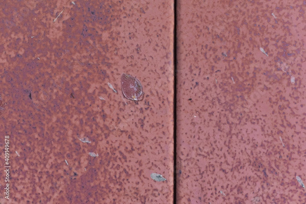 Fototapeta Plate of metal rusty texture with traces of red paint faint color corroded with age in Sofia, Bulgaria, Eastern Europe