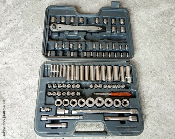 Fototapeta An open tool box placed on the above view. Car accessories or spare parts, garage.