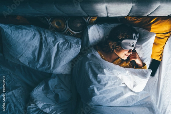 Obraz Woman sleeping with a sleep mask on her eyes