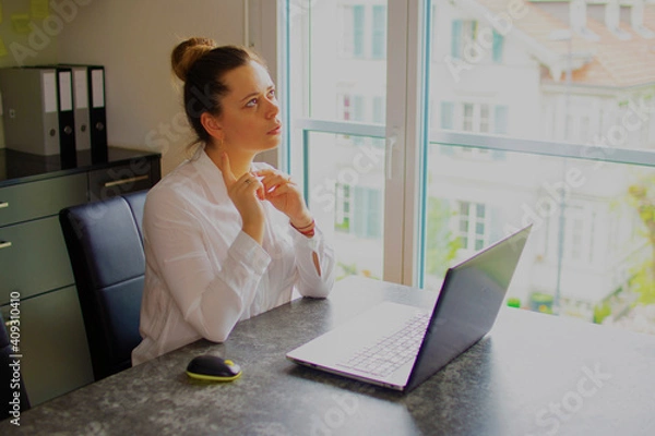 Fototapeta Office worker girl thinks over the project