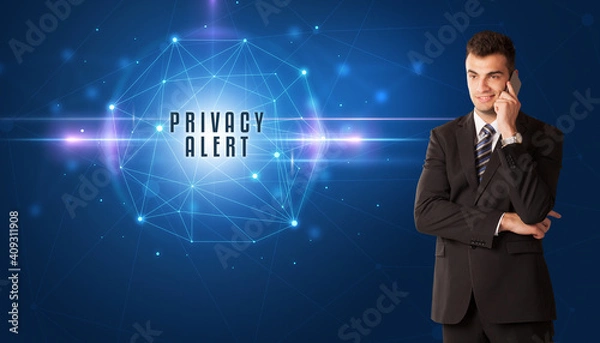 Fototapeta Businessman thinking about security solutions with PRIVACY ALERT inscription