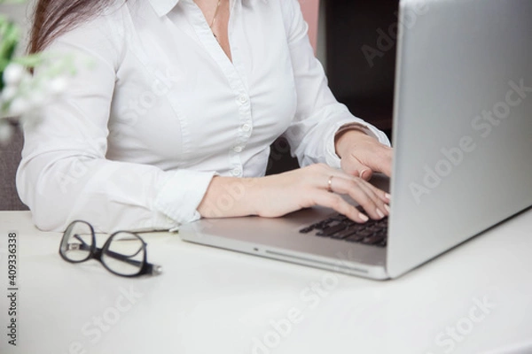 Obraz Work from home, e-learning, online learning concept. Close-up, business woman working, hand typing on laptop computer, searching the internet at the table in modern home office. Student studying at ho