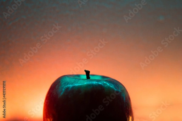 Fototapeta red apple on the sunset