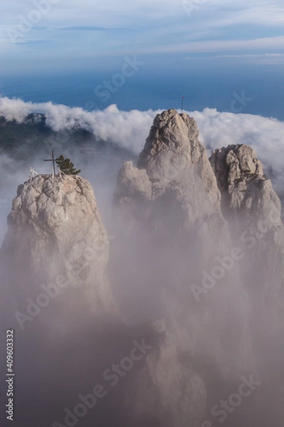 Fototapeta clouds under the three mountain peaks