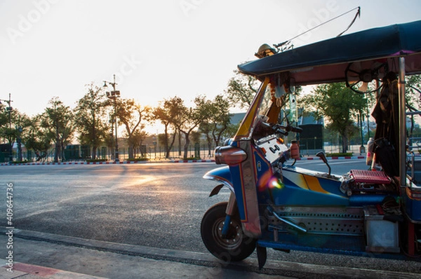 Fototapeta Thai tuk-tuks land on the road at sunset.