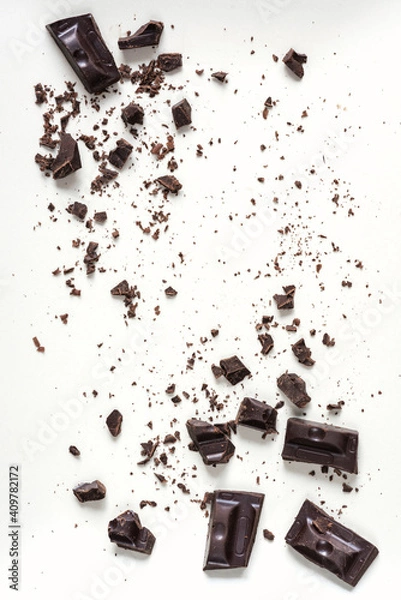 Obraz Pieces of dark chocolate bar on a light background. Top view, flat lay, copy space.