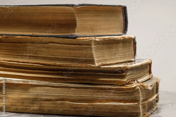 Fototapeta Close-up of several old and antique books arranged in rows. Bookshelf - Selective focus background with shallow depth of field.