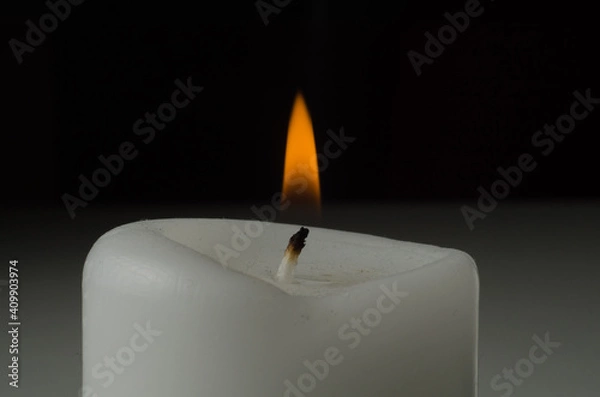 Obraz burning candle on black background
