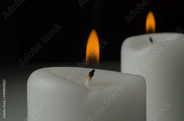 Obraz burning candle on black background