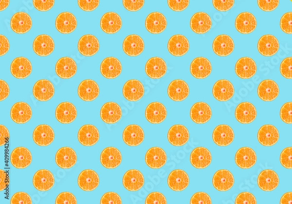 Fototapeta Fresh oranges  pattern on blue background. Minimal concept. Summer minimal concept. Flat lay.