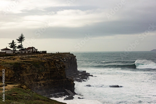 Fototapeta Wave breaking near a cliff during the winter in the coast of Portugal