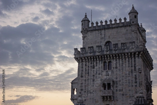 Fototapeta Zoom of the Belem tower with a colorful and cloudy sky in the background - Portugal images