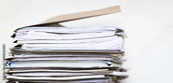 Fototapeta Extremely Close up Stack of Documents Folders on Office Desk Waiting to be Completed.