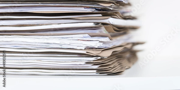 Fototapeta Extremely Close up Stack of Documents Folders on Office Desk Waiting to be Completed.