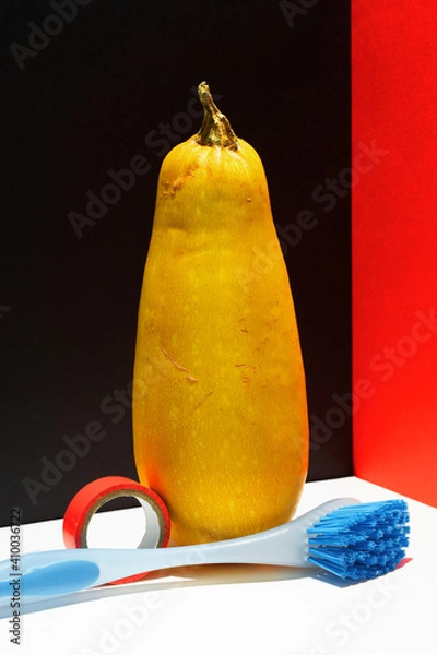 Obraz Zucchini, duct tape and brush over modern black white red background.