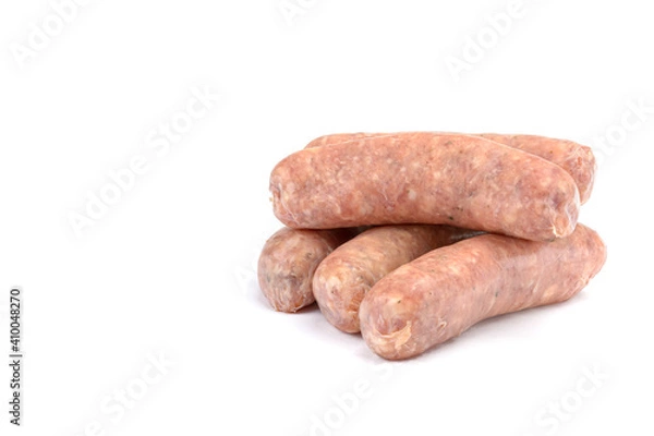 Fototapeta Raw pork sausages.Grilled sausages in close-up, isolated on a white background.Selective focus.