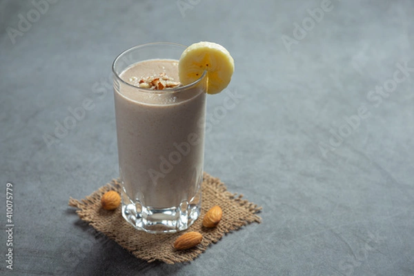 Obraz Banana almond smoothie on dark background