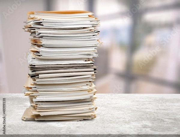 Fototapeta Stack of document papers on stone desk
