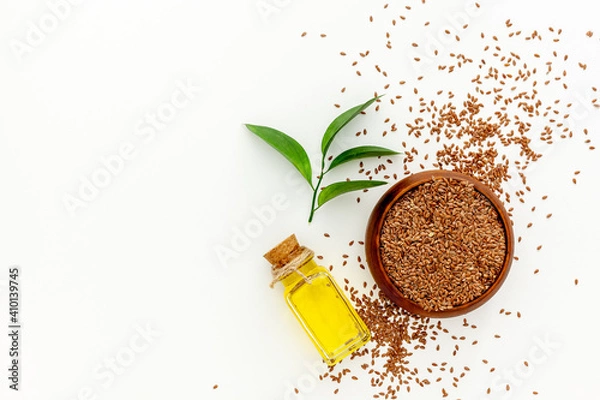Obraz Flax seeds in a spoon and bowl with a bottle of flaxseed oil