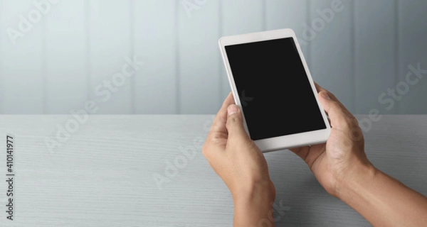 Fototapeta Hands holding  tablet touch computer gadget with  screen