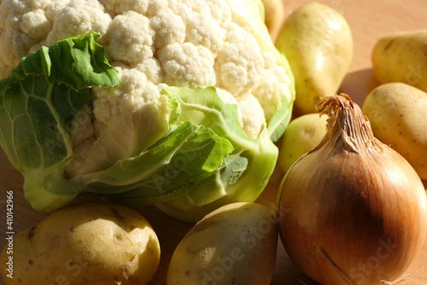 Fototapeta Prepared fresh raw vegetable mix for cooking consisting of cauliflower, potatoes and onion