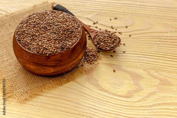 Obraz Flax seeds in a spoon and bowl with a bottle of flaxseed oil