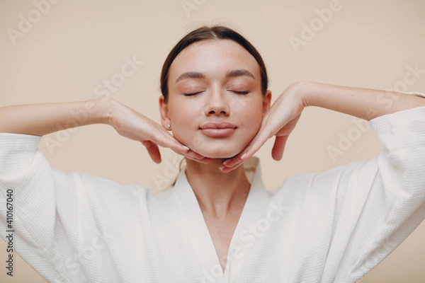 Fototapeta Young woman doing face building yoga facial gymnastics self massage and rejuvenating exercises