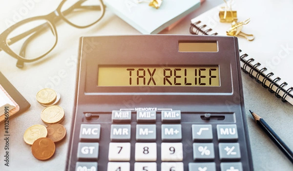 Fototapeta Word TAX RELIEF. Written on a calculator on an office desk.
