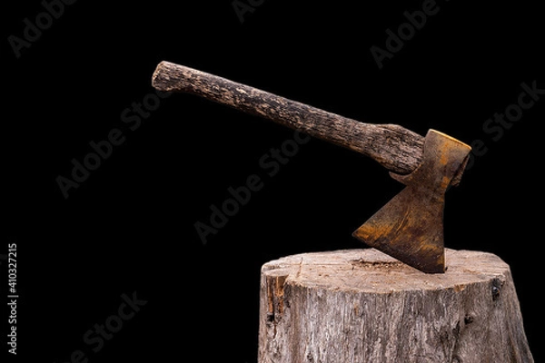 Fototapeta Old Axe stuck in a tree on a black background