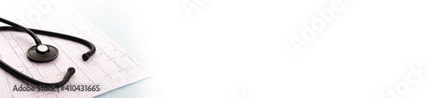 Fototapeta Stethoscope on cardiogram on blue background. Cardiology concept. Panoramic web banner with copy space for your text.