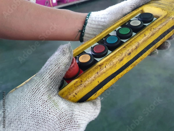 Obraz A man operating a crane