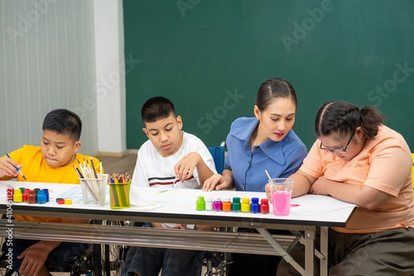 Obraz Asian disability boy learning color Painting in classroom with Autism girl in special school with female teacher.