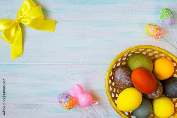 Fototapeta Colored Easter eggs with decor and yellow bow. Blank space for text in the middle