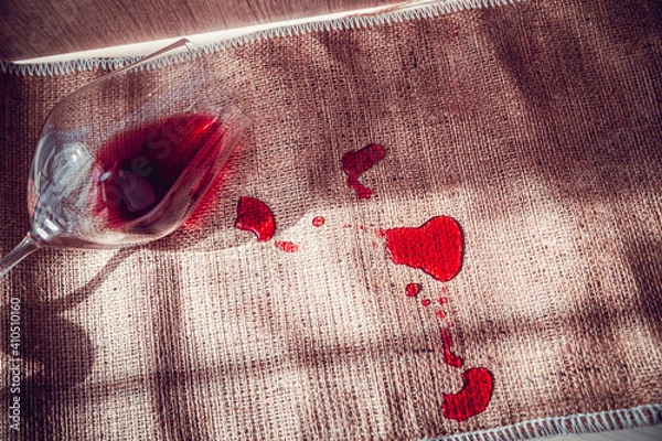 Fototapeta poured red wine on the table, drops of red wine