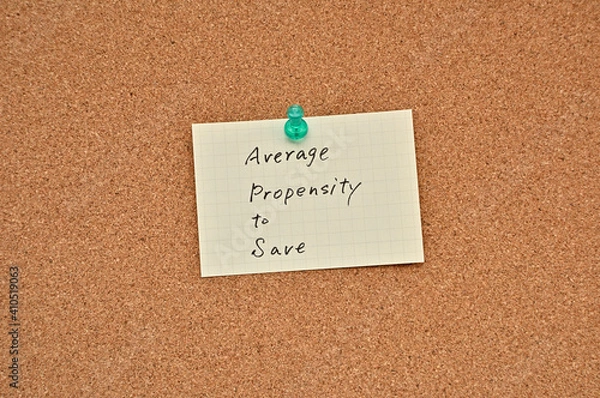 Fototapeta A piece of paper labeled average propensity to save is pinned to the corkboard.