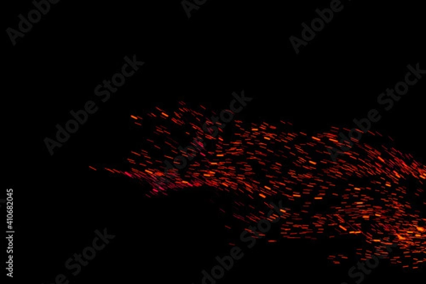 Fototapeta Flying red fire sparks on black background overlay