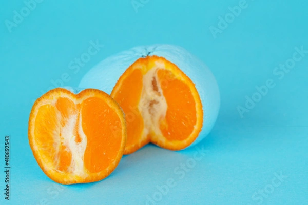 Fototapeta Turquoise tangerine on a turquoise background. Fake and GMO concept