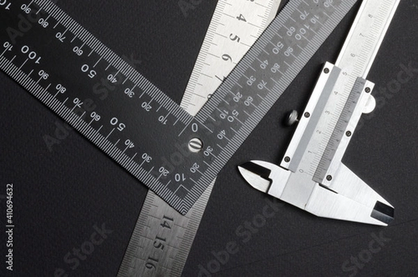 Fototapeta measuring tool, ruler square and caliper. lie on a dark background. close-up.