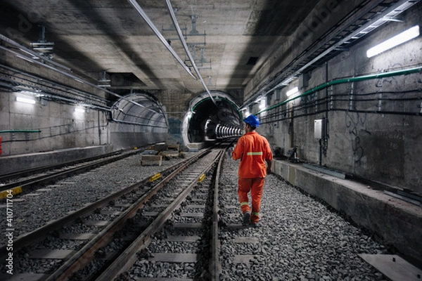 Fototapeta worker walking at railway tunnel