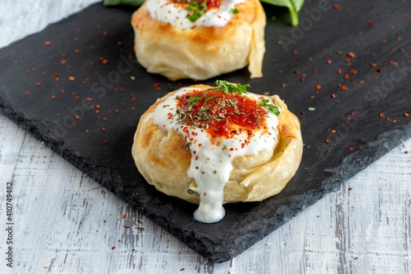 Fototapeta Traditional Turkish Borek with minced meat and yogurt. Yoghurt Burek Dumplings