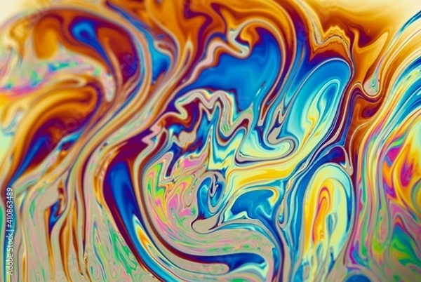 Fototapeta Brightly ornamental background with abstract patterns in dominant fiery orange color. Modern liquid art.  Mixed colors in soap bubbles, closeup.