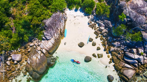 Fototapeta A top view over Koh Lipe island with the crystal clear water and people were doing kayaking.