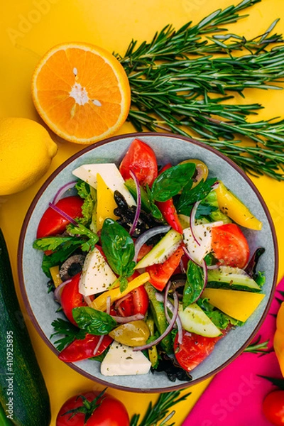 Fototapeta healthy food. Greek Salad with cheese, cucumbers, tomatoes and olives on a decorated table