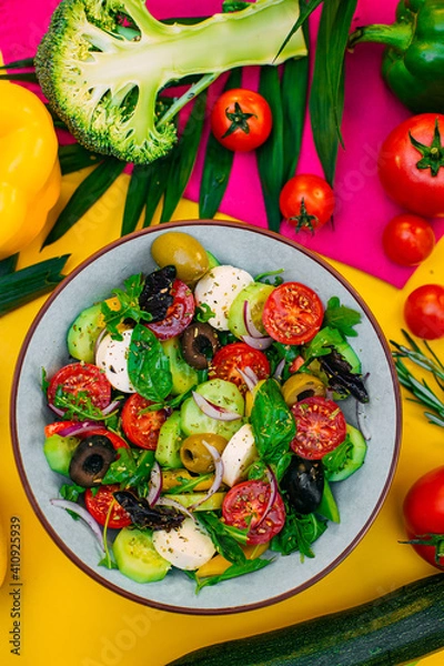 Fototapeta healthy food. Greek Salad with cheese, cucumbers, tomatoes and olives on a decorated table