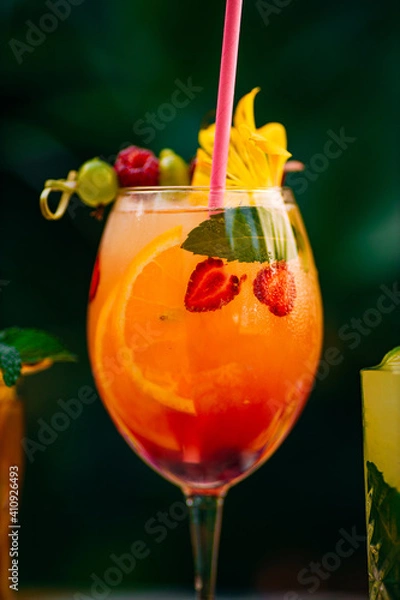 Obraz tropical cocktail with berries and fruits on a decorated table